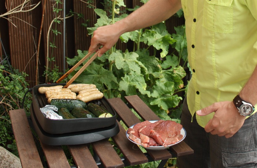 Delicious outdoor dinner in the process of becoming delicious.