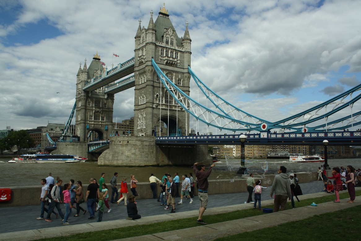 Many tourists crowd at the river banks to take that photo of the bridge. Our kids watch some guys blowing giant soap bubbles.