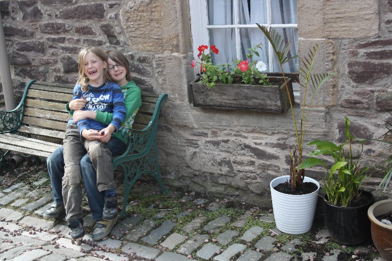 Two happy boys in front of the youth hostel in one of the mill buildings. 